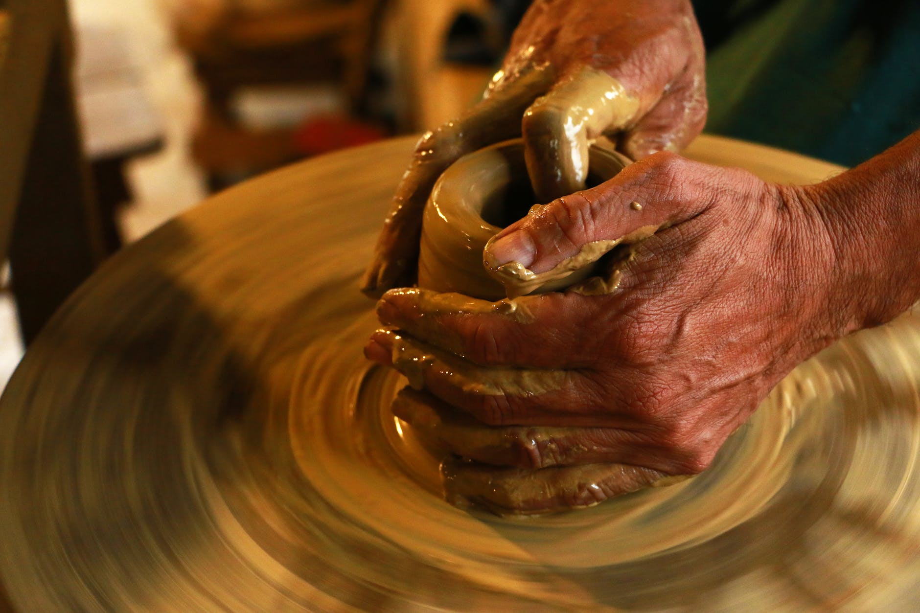 selective focus photography of person molding clay